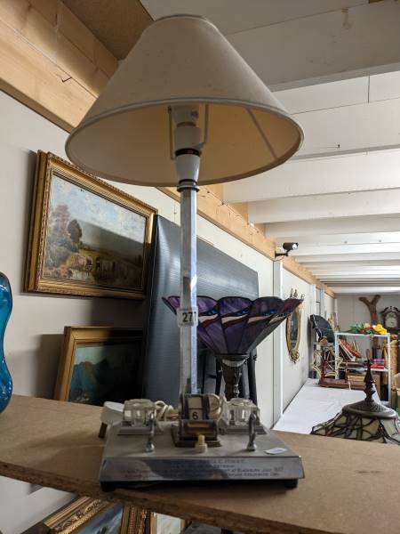 A vintage chrome table lamp incorporating an ink stand.