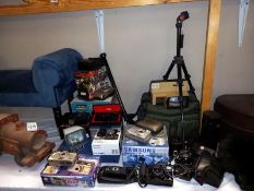 A good lot of camera's, empty slide magazines & view finders etc.