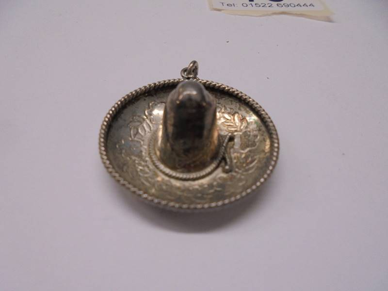 A silver sombrero pendant, a silver axe brooch and a silver button hole holder 10 grams. - Image 2 of 5