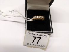 A 9ct gold seven stone ring, size Q. 2.6 grams.
