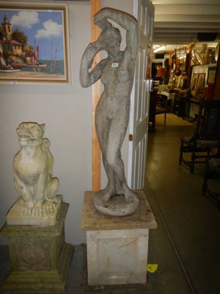A nude female statue on pedestal. COLLECT ONLY.