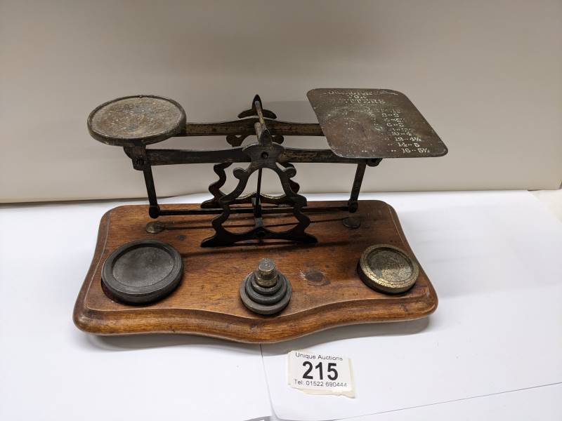 A set of Victorian brass postal scales with weights,