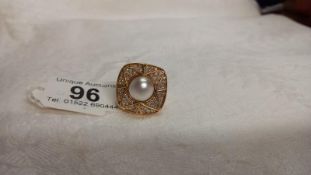 A diamond plaque ring, centre pearl with 1.20 carats of diamonds on the surround in 18ct gold,