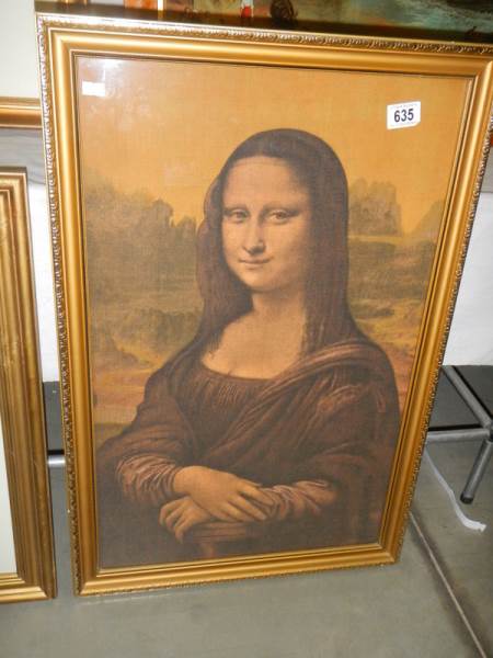 A framed print on silk of the Mona Lisa. 74 x 49 cm.
