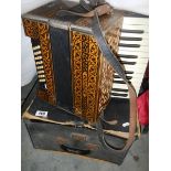 A Hohner Piano accordian in case (case distressed).