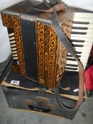 A Hohner Piano accordian in case (case distressed).