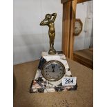 An art deco marble mantel clock surmounted figure, base 13 x 4.5 cm, height 19.5 cm.