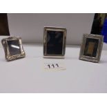 Three small silver photo frames, 7 x 5 cm, 6 x 4.5 cm and 5 x 3.5 cm.