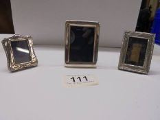 Three small silver photo frames, 7 x 5 cm, 6 x 4.5 cm and 5 x 3.5 cm.