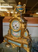 A French ormolu mantel clock with Sevres porcelain panels.