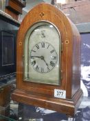 A Victorian arch top inlaid bracket clock with chased silvered dial and Westminster chime,
