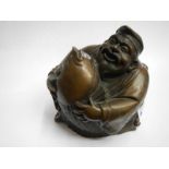 A bronze laughing Buddha.