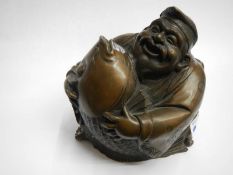 A bronze laughing Buddha.