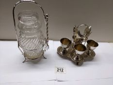 A silver plate egg cup stand and a pickle jar on silver plate stand.