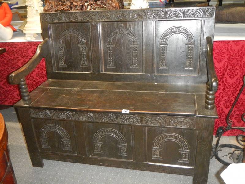 A Victorian carved oak monk's bench.