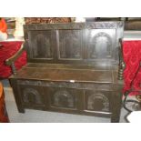 A Victorian carved oak monk's bench.