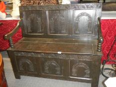 A Victorian carved oak monk's bench.