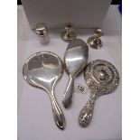 Two silver hand mirrors, a silver hair brush, silver lidded pot and pair of silver candlesticks.