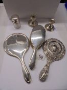 Two silver hand mirrors, a silver hair brush, silver lidded pot and pair of silver candlesticks.