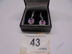 A pair of 18ct white gold pink sapphire and diamond earrings.