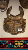 An African tribal mask (with carved horns)