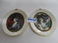 A pair of bone framed oval signed miniatures.