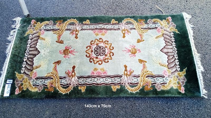 A green & beige rug with dragon pattern - 143cm x 70cm (COLLECT ONLY)