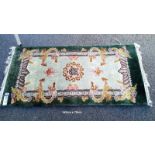 A green & beige rug with dragon pattern - 143cm x 70cm (COLLECT ONLY)