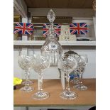 A cut glass decanter and six goblets.