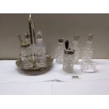 A four bottle cruet set, 4 cruet bottles and a napkin ring.