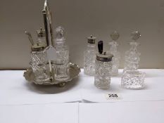 A four bottle cruet set, 4 cruet bottles and a napkin ring.