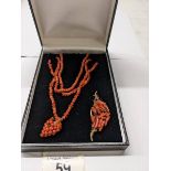 A red coral necklace with attached pendant and a 19th century similar brooch.