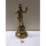 A Victorian brass figure bar top mains gas lighter, 24 cm tall.