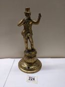 A Victorian brass figure bar top mains gas lighter, 24 cm tall.