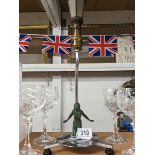 An original chrome art deco table lamp with verdigree spelter kneeling nude