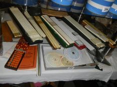 A mixed lot of various slide rules including circular types.