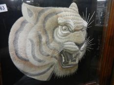 A framed and glazed embroidered tiger head. COLLECT ONLY.