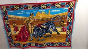 A large fabric wall hanging of a Spanish bull fight, approximately 150cm x 100cm