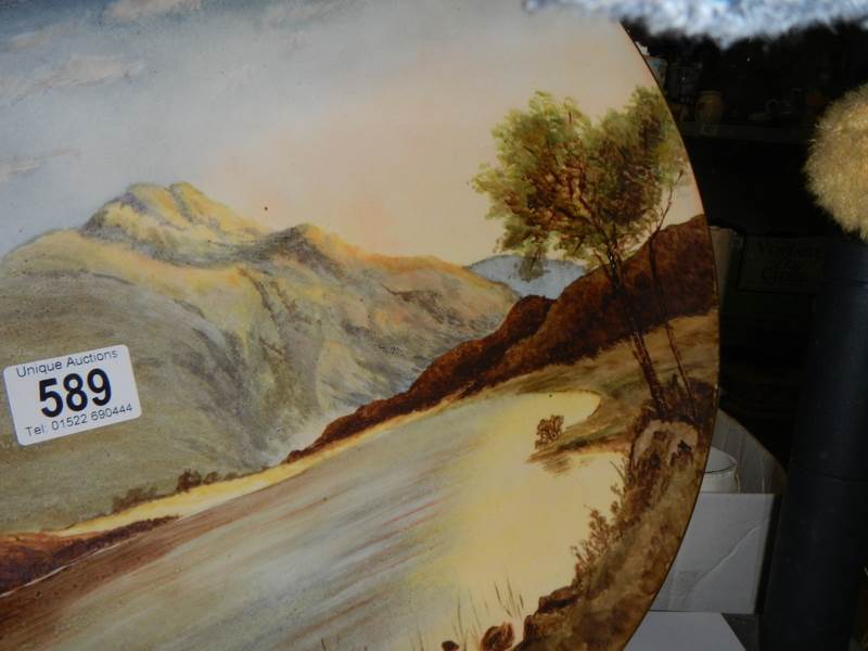 A hand painted wall plaque featuring mountains by Doulton artist M W K Blair, 36 cm diameter. - Image 2 of 3