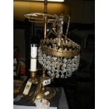 An early 20th century double brass table lamp and a glass ceiling light.