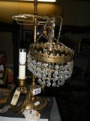 An early 20th century double brass table lamp and a glass ceiling light.