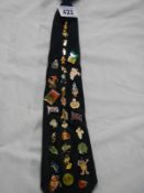 A collection of pin badges on a tie.