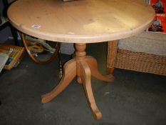 A Pine pedestal kitchen table. COLLECT ONLY.