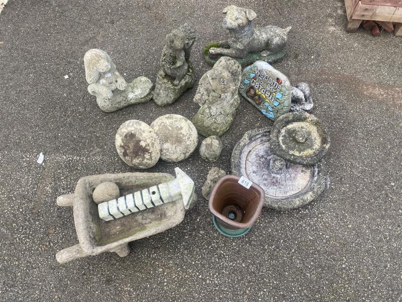 A collection stone garden sculptures including dog and squirrel