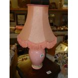 A pink ceramic table lamp.