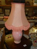 A pink ceramic table lamp.