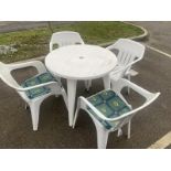 A plastic garden set including table and 4 chairs