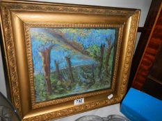 A gilt framed woodland scene.