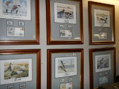 A set of six framed and glazed bird prints with first day covers.