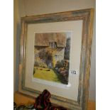 A framed and glazed thatched cottage scene.